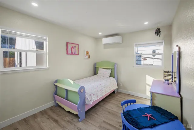 a bedroom with a bed and painting on the wall