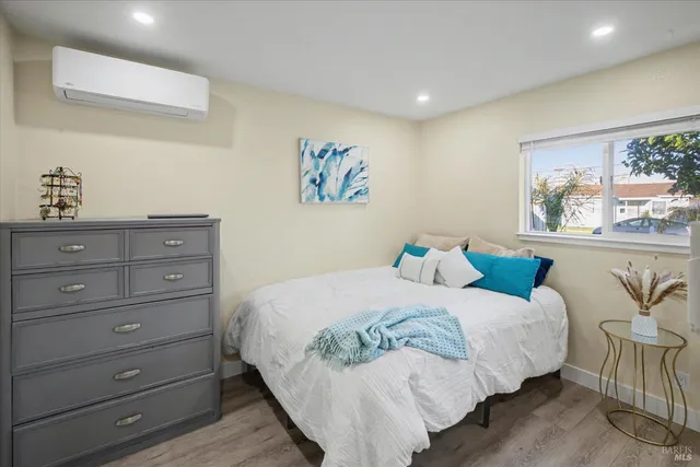 a bedroom with a bed and a painting on the wall