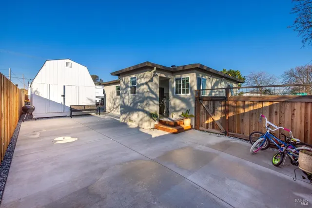 a view of a pathway of a building with wooden fence
