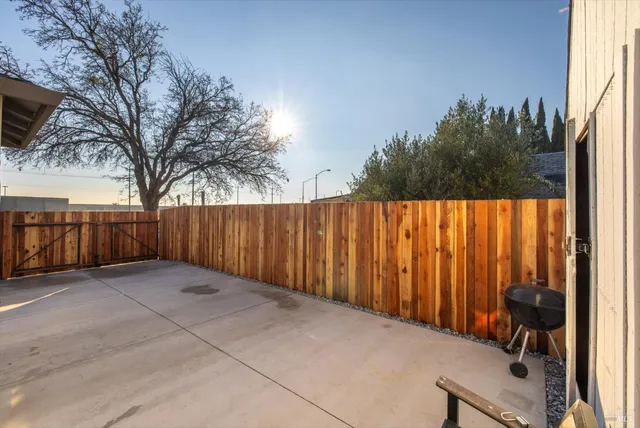 a view of a balcony with furniture and a potted plant