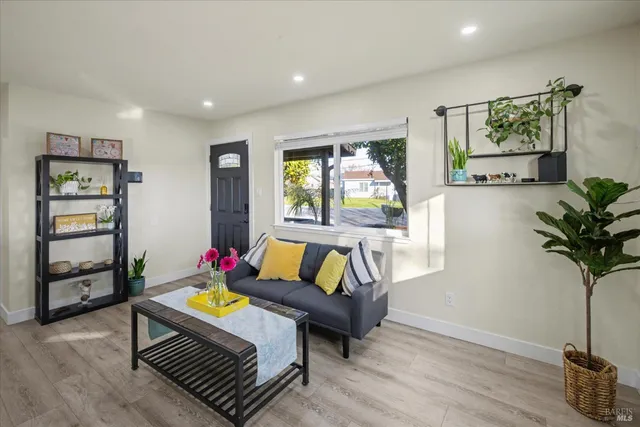 a kitchen with a table chairs and white cabinets