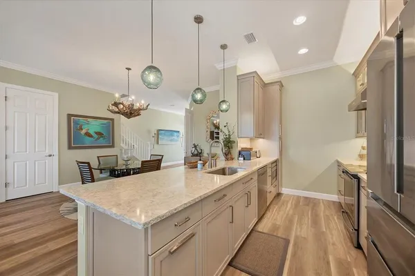 a large kitchen with lots of counter space and a sink