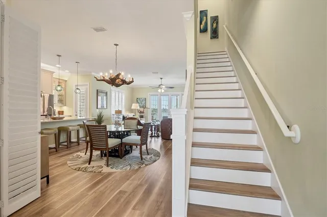a bedroom with a large bed and a chandelier
