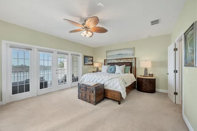 a spacious bedroom with a bed and a chandelier