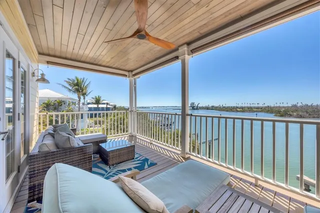 a view of a lake with couches chairs