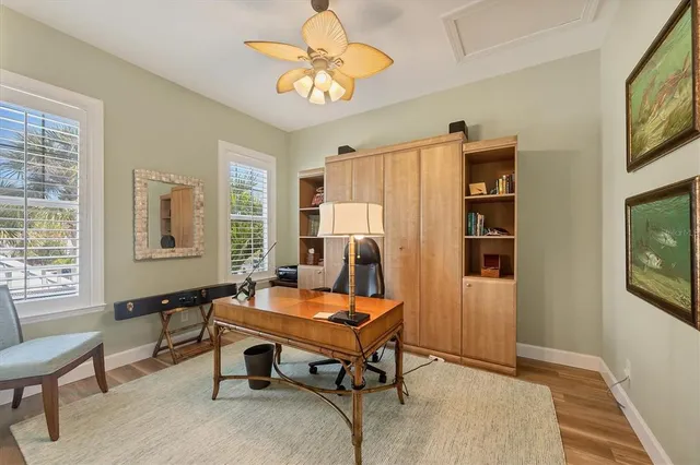 a bathroom with a granite countertop sink a toilet a mirror a vanity and shower
