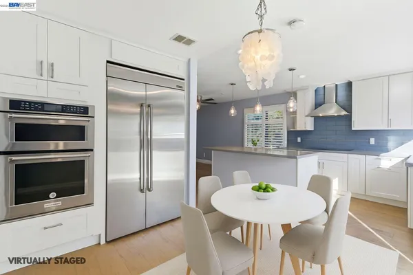 a view of a kitchen with a dining table and chairs