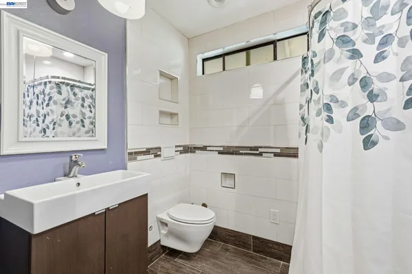 a bathroom with a sink mirror toilet and vanity