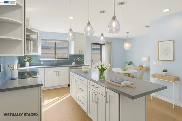 a kitchen with center island a sink appliances and cabinets