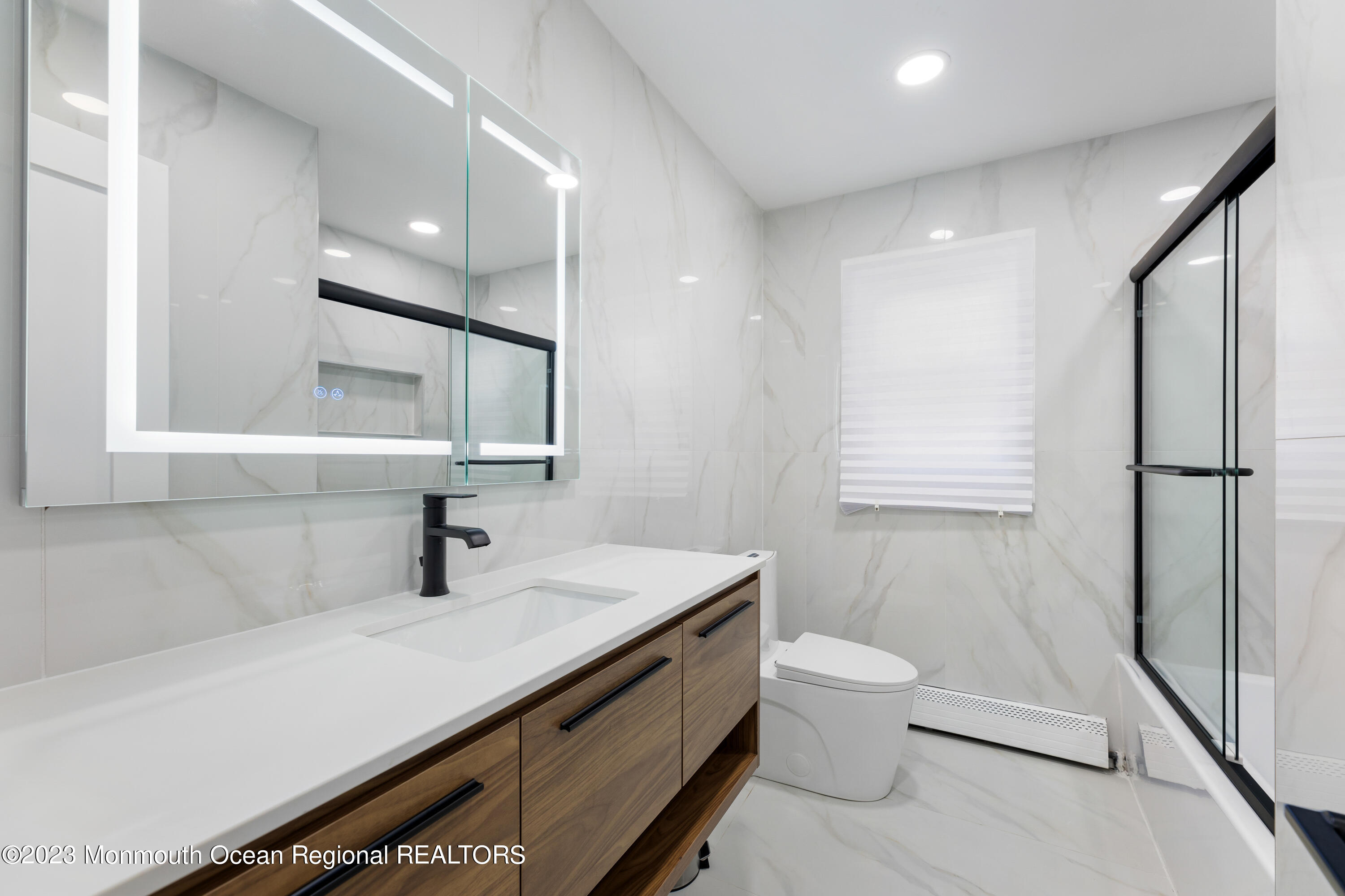 186 Delaware Avenue, Unit WINTER Oakhurst, NJ 07755 - Photo 11 of 31 a bathroom with a sink a toilet and mirror
