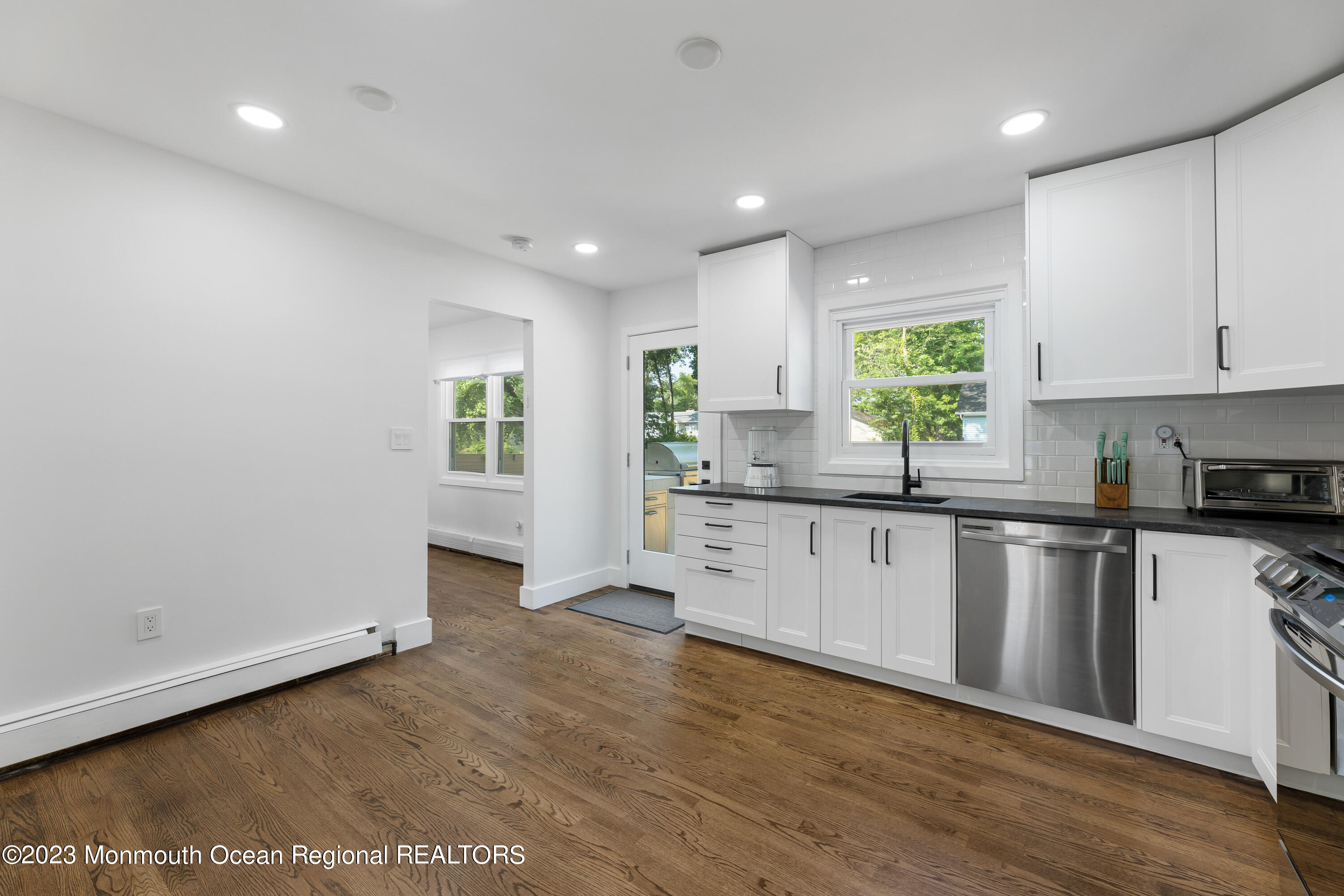 186 Delaware Avenue, Unit WINTER Oakhurst, NJ 07755 - Photo 13 of 31 a kitchen with granite countertop white cabinets and window