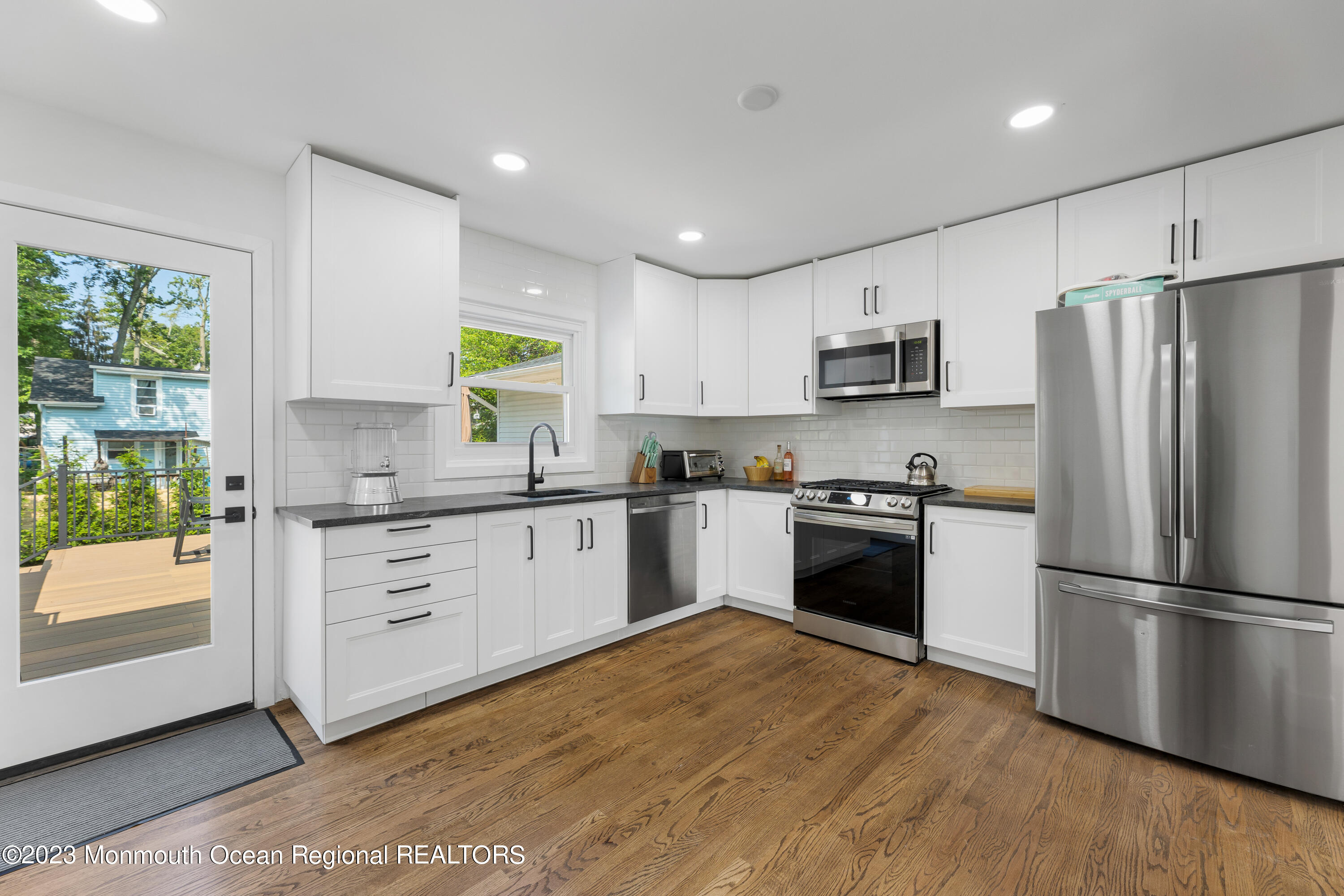 186 Delaware Avenue, Unit WINTER Oakhurst, NJ 07755 - Photo 14 of 31 a kitchen with a refrigerator and a stove top oven