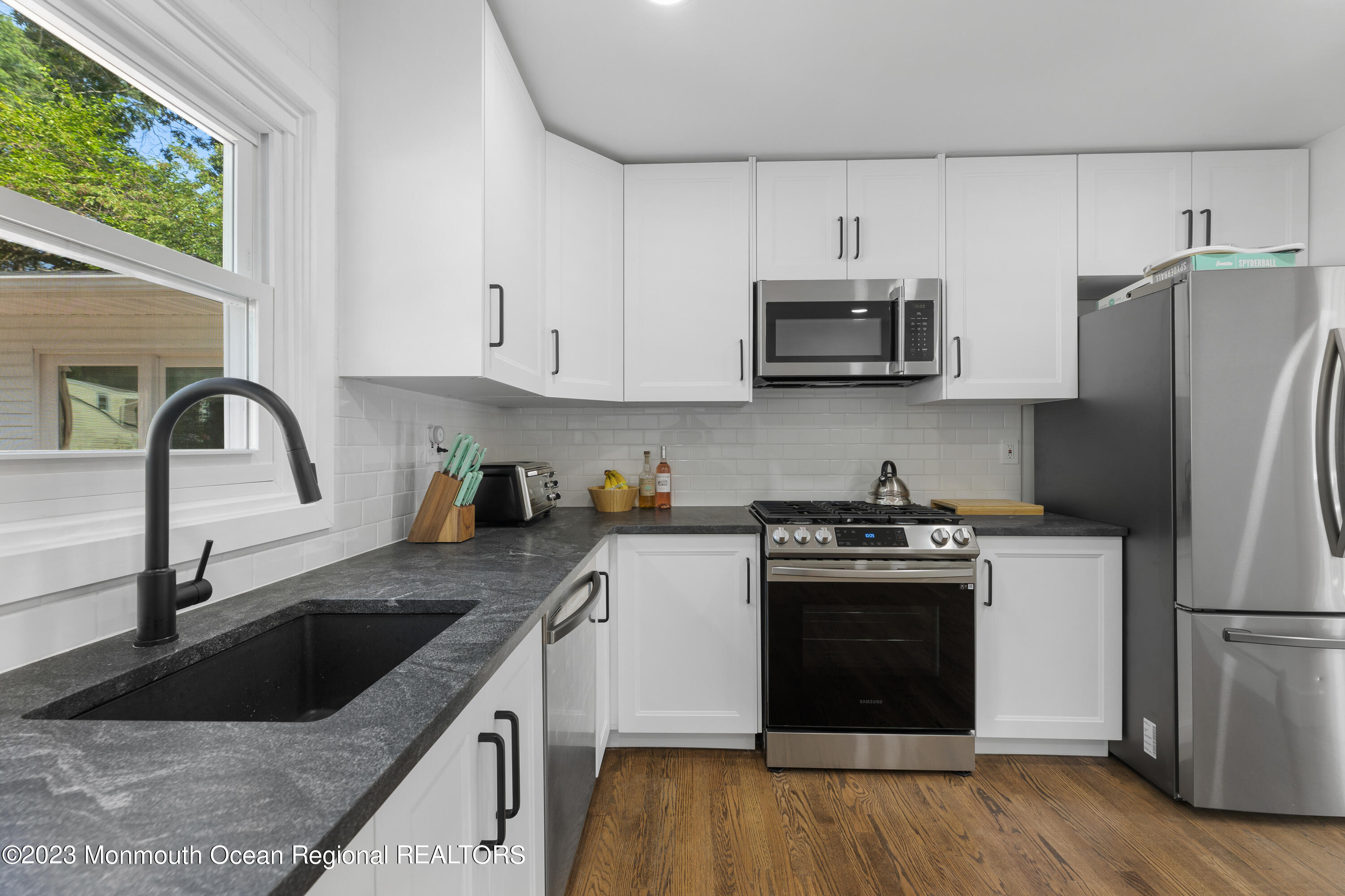 186 Delaware Avenue, Unit WINTER Oakhurst, NJ 07755 - Photo 15 of 31 a kitchen with stainless steel appliances granite countertop a sink stove and refrigerator