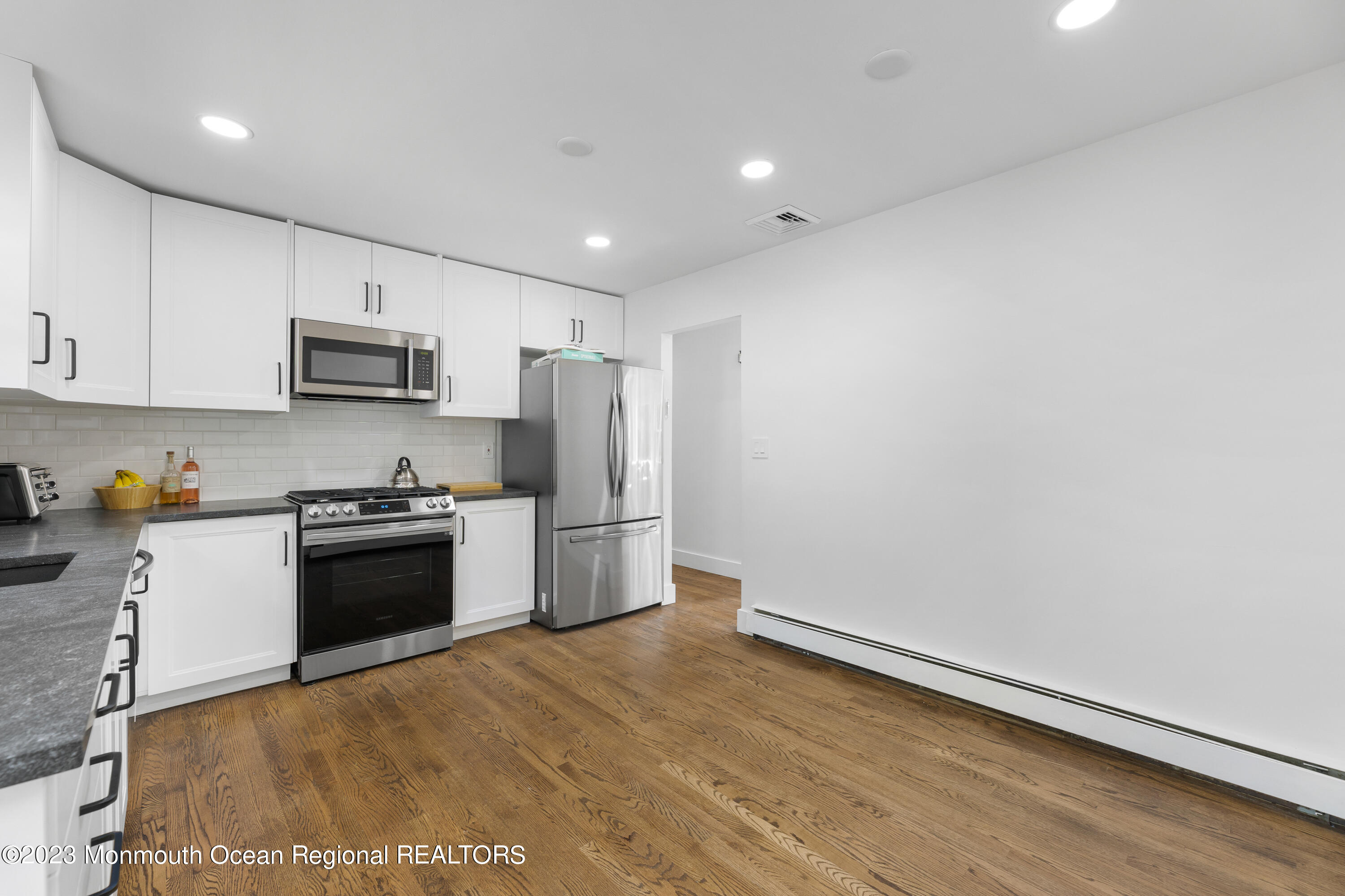 186 Delaware Avenue, Unit WINTER Oakhurst, NJ 07755 - Photo 16 of 31 a kitchen with granite countertop a refrigerator and a stove top oven