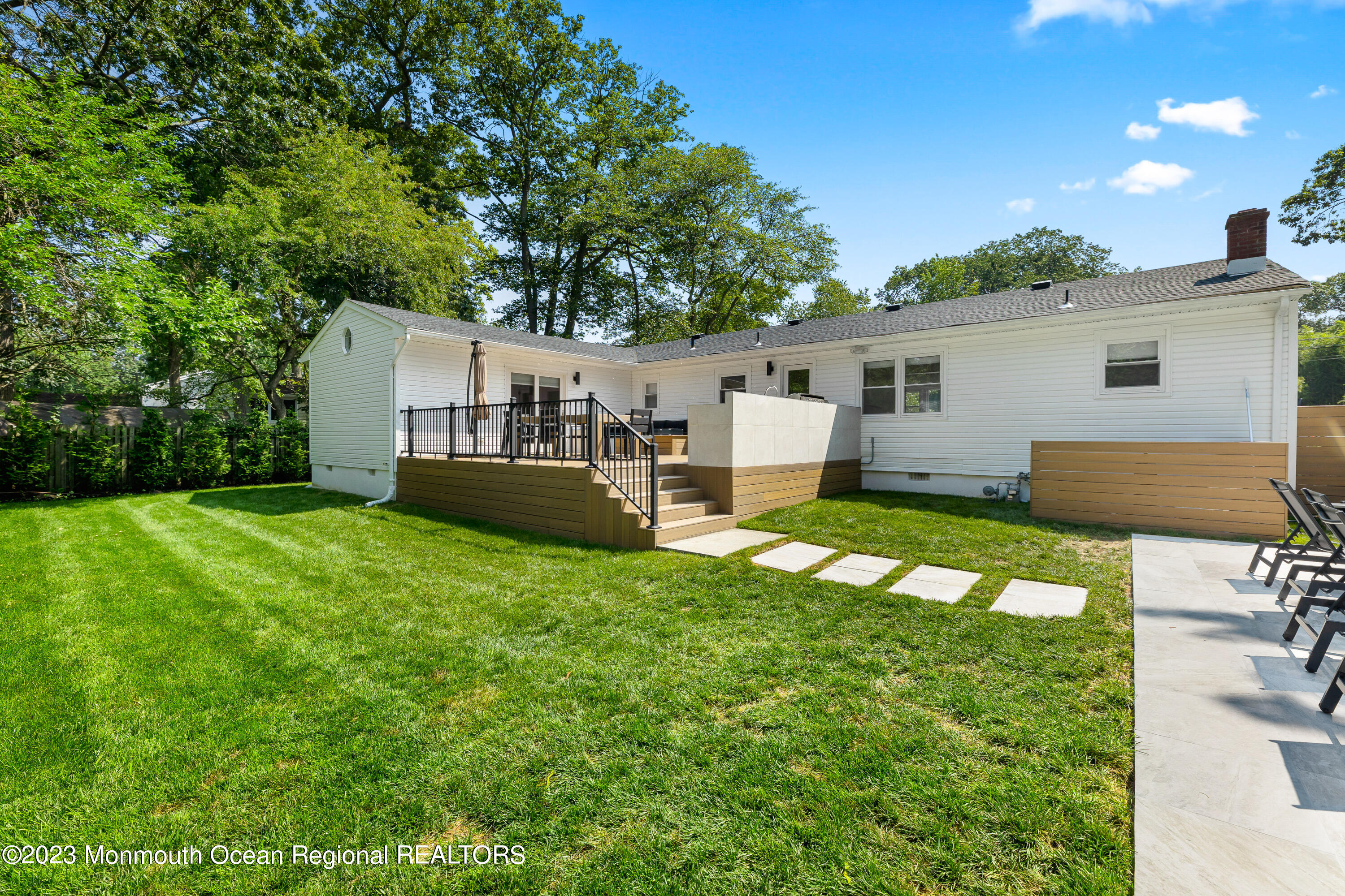 186 Delaware Avenue, Unit WINTER Oakhurst, NJ 07755 - Photo 24 of 31 a view of a house with backyard and a garden