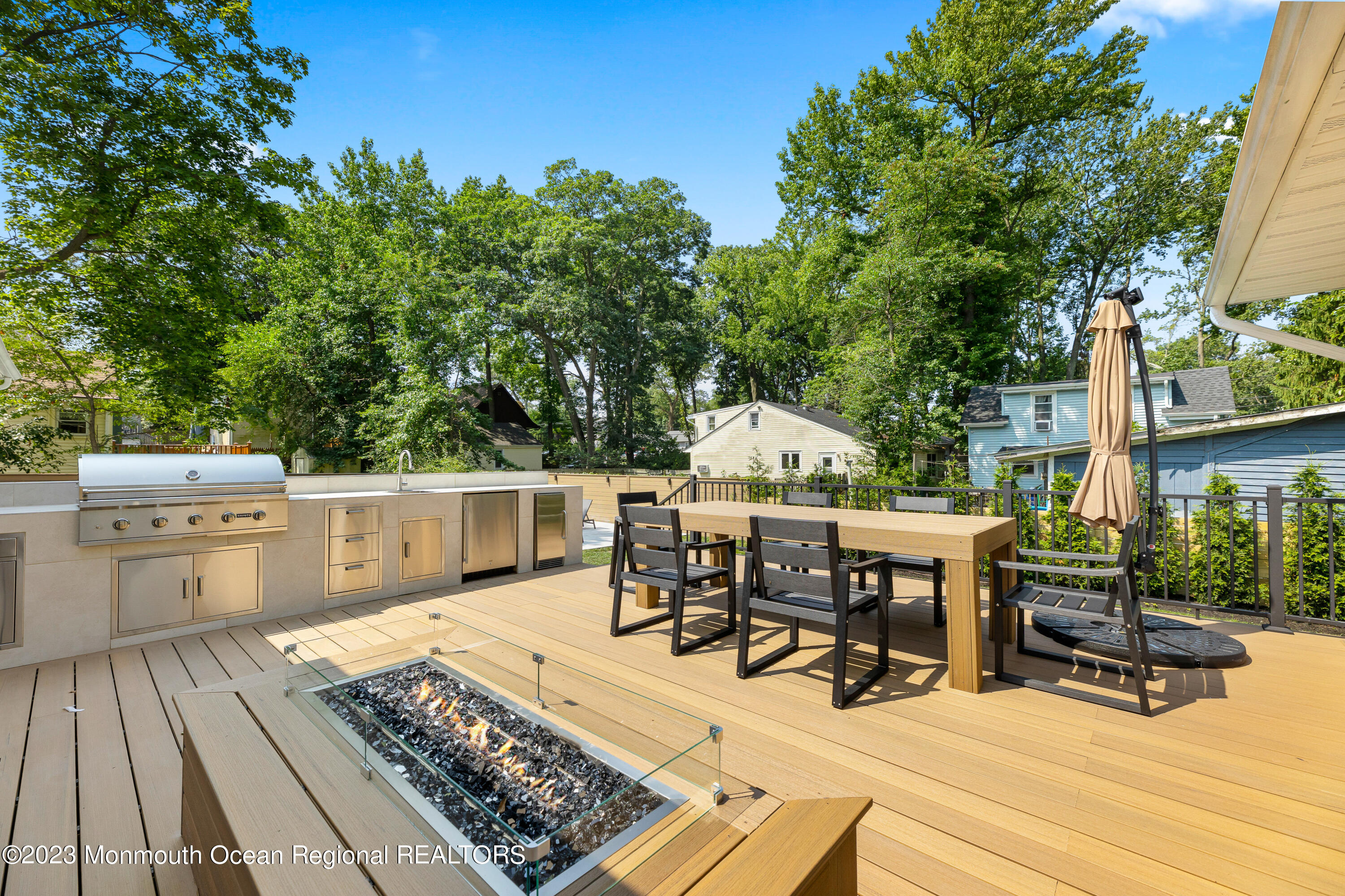186 Delaware Avenue, Unit WINTER Oakhurst, NJ 07755 - Photo 27 of 31 a view of a patio with table and chairs floor to ceiling window with wooden floor