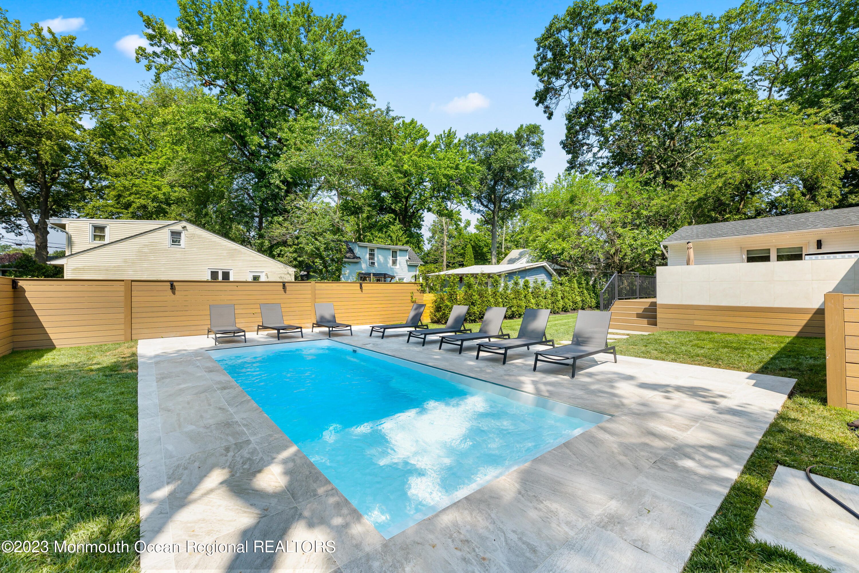 186 Delaware Avenue, Unit WINTER Oakhurst, NJ 07755 - Photo 31 of 31 a view of a swimming pool with a patio