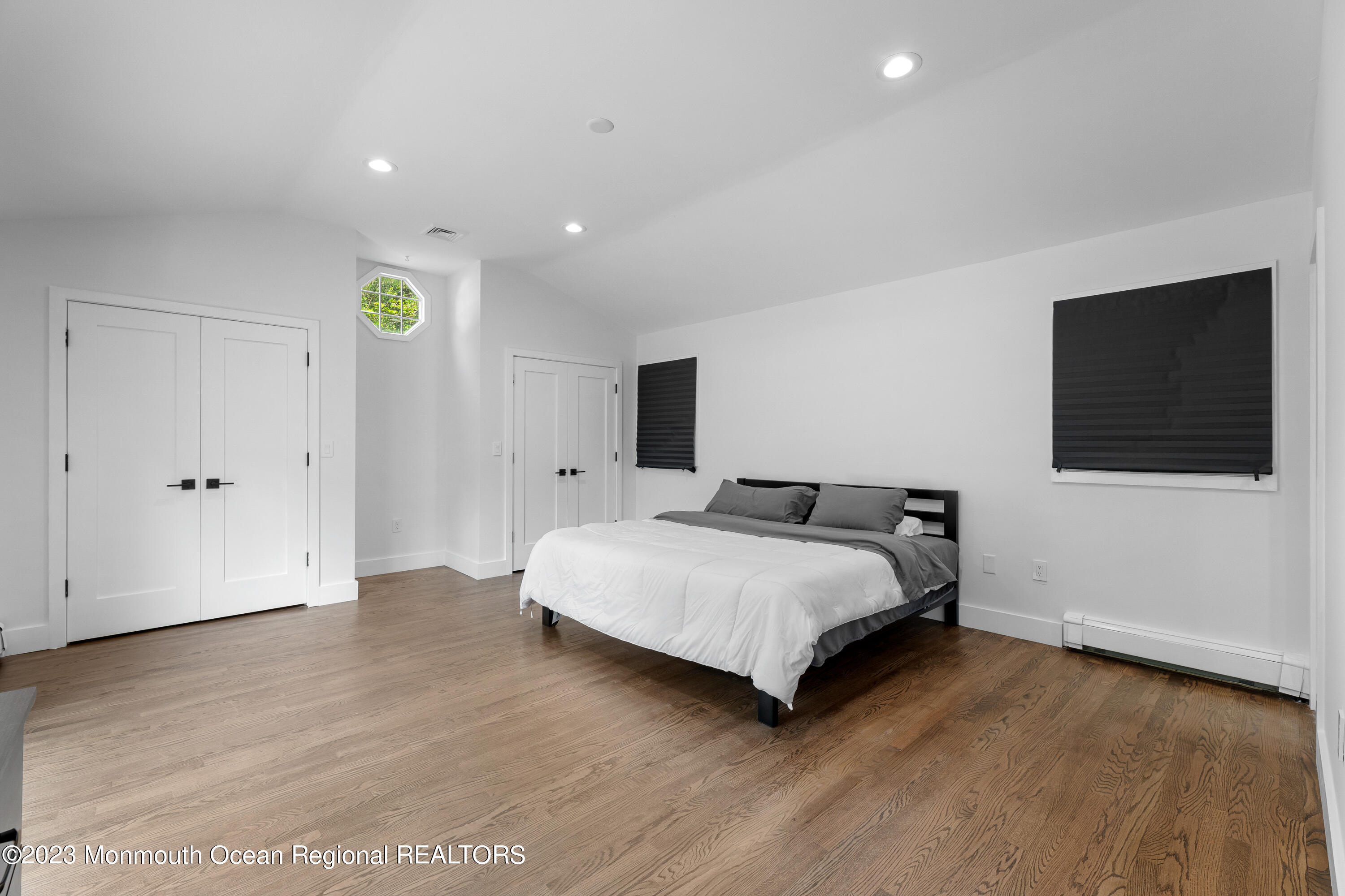 186 Delaware Avenue, Unit WINTER Oakhurst, NJ 07755 - Photo 5 of 31 a spacious bedroom with a bed and a flat screen tv