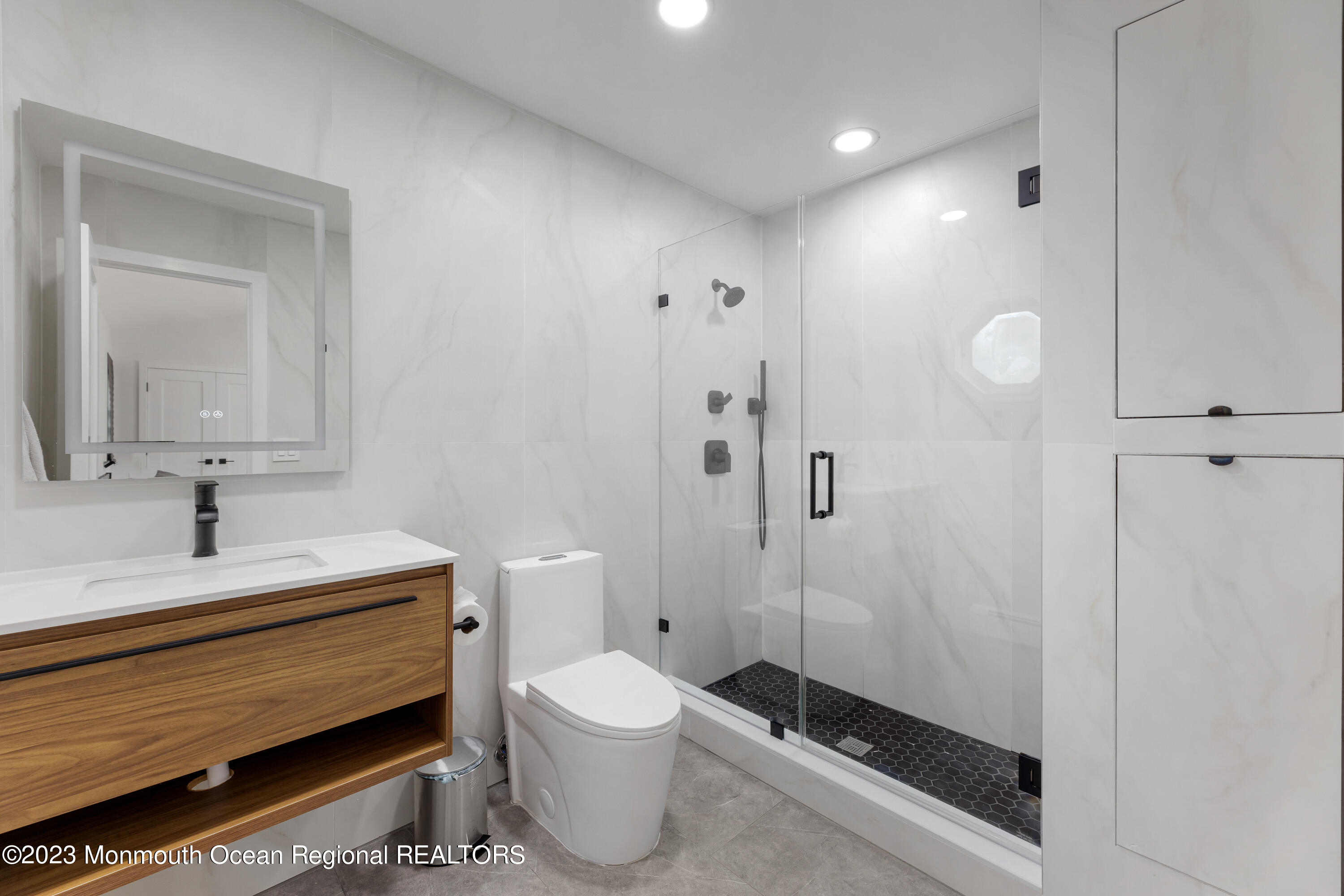 186 Delaware Avenue, Unit WINTER Oakhurst, NJ 07755 - Photo 7 of 31 a bathroom with a toilet sink a mirror and shower