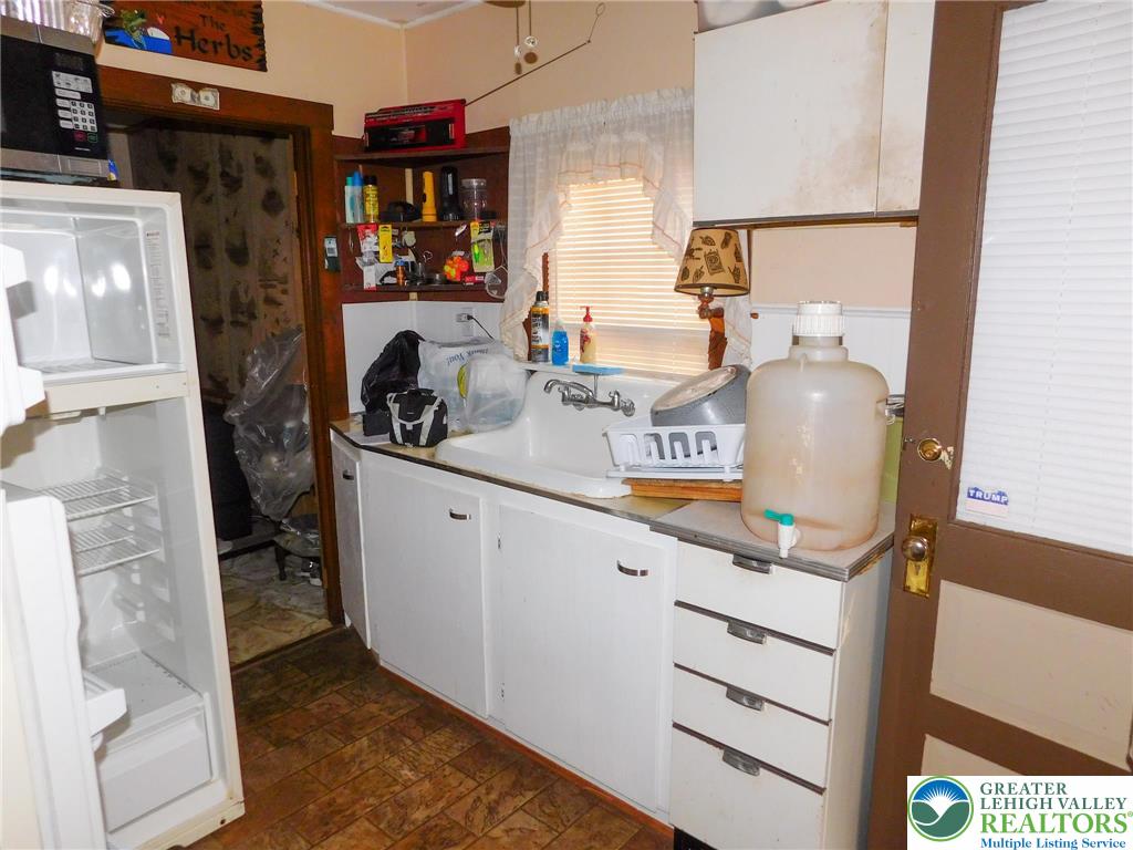 156 Pine Flats Colony Road Dingmans Ferry, PA 18328 - Photo 5 of 16 a kitchen with a refrigerator and a stove