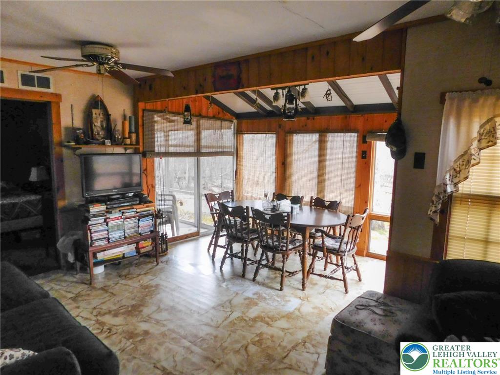 156 Pine Flats Colony Road Dingmans Ferry, PA 18328 - Photo 6 of 16 a living room with furniture and a flat screen tv