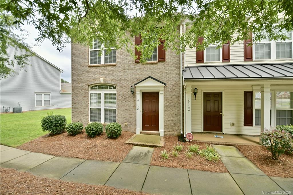 6152 Prosperity Church Road Charlotte, NC 28269 - Photo 2 of 33 a view of a brick house with a large windows and large trees