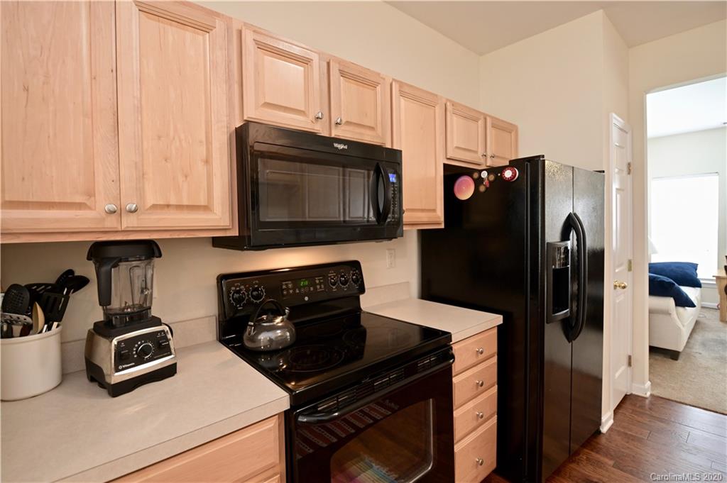 6152 Prosperity Church Road Charlotte, NC 28269 - Photo 11 of 33 a kitchen with stainless steel appliances granite countertop a refrigerator stove and microwave