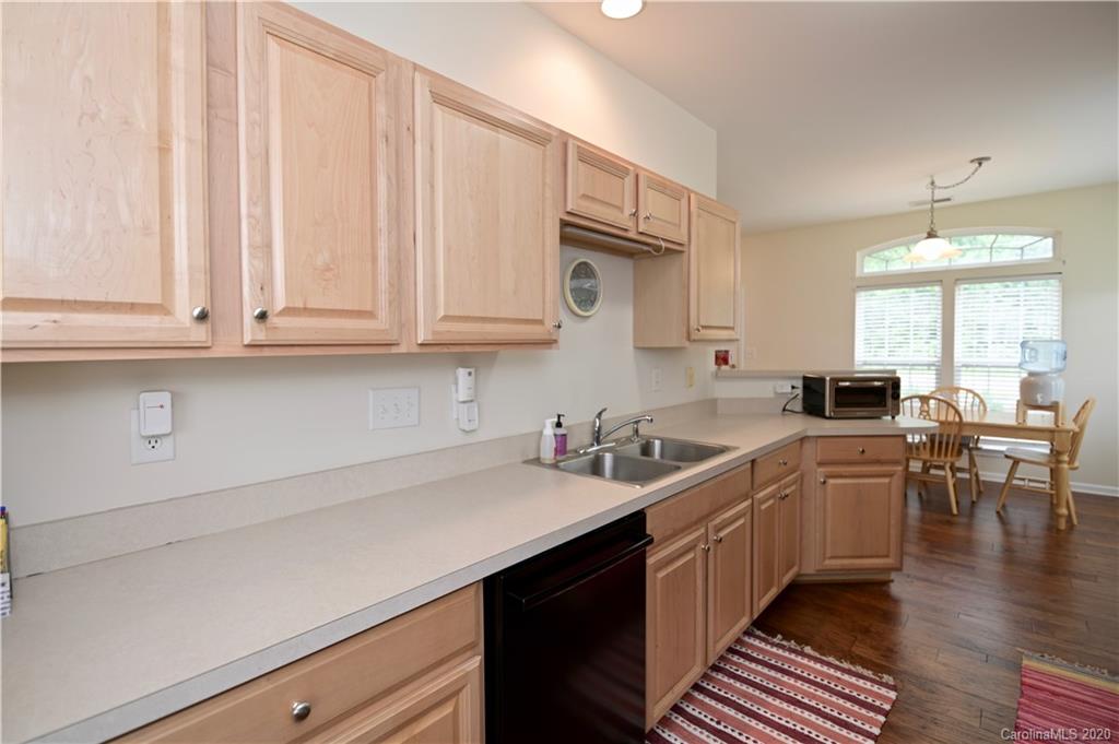 6152 Prosperity Church Road Charlotte, NC 28269 - Photo 12 of 33 a kitchen with white cabinets and sink