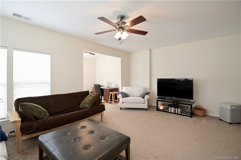 6152 Prosperity Church Road Charlotte, NC 28269 - Photo 14 of 33 a living room with furniture and a flat screen tv