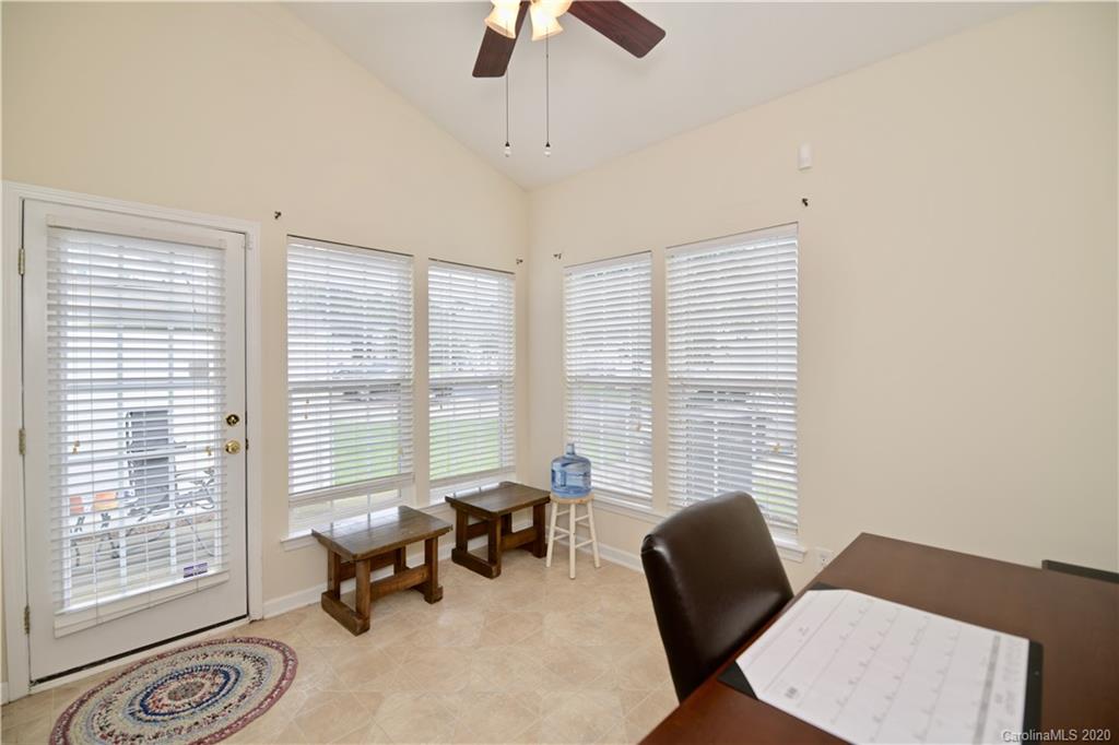 6152 Prosperity Church Road Charlotte, NC 28269 - Photo 19 of 33 a living room with furniture and a floor to ceiling window