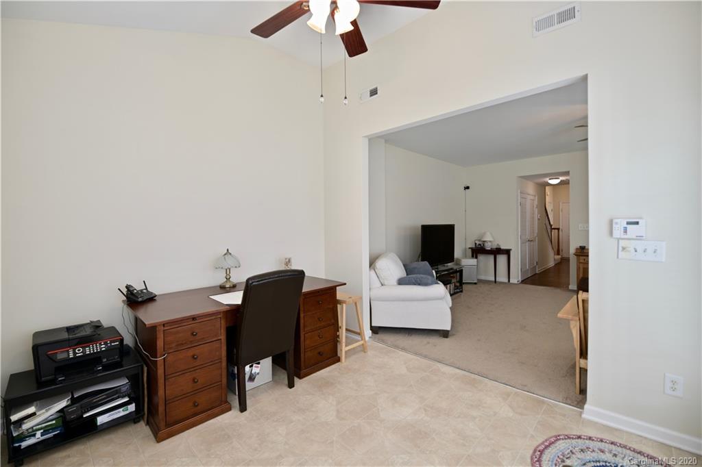 6152 Prosperity Church Road Charlotte, NC 28269 - Photo 21 of 33 a bedroom with a bed and a chandelier