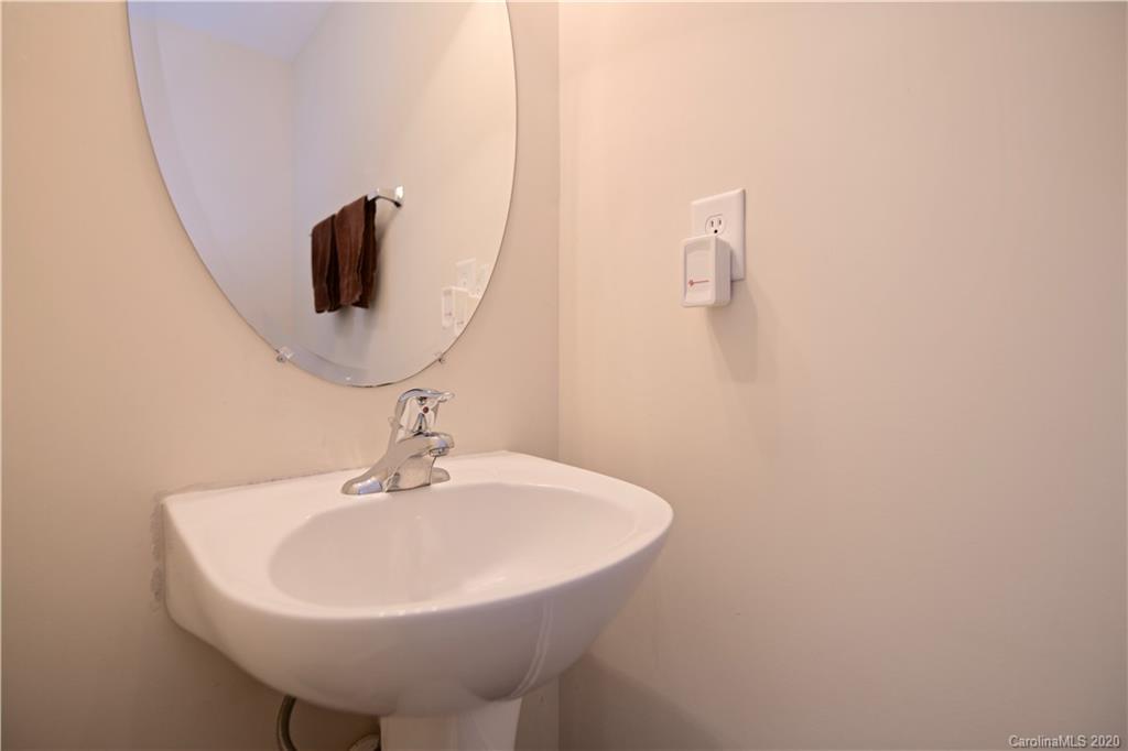 6152 Prosperity Church Road Charlotte, NC 28269 - Photo 22 of 33 a bathroom with a sink and a mirror