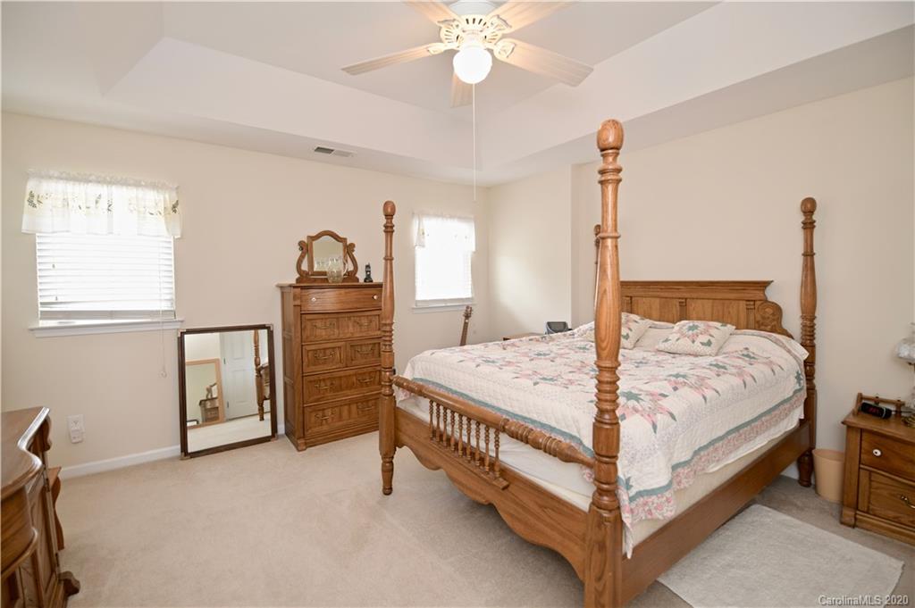 6152 Prosperity Church Road Charlotte, NC 28269 - Photo 23 of 33 a bedroom with a bed and a dresser