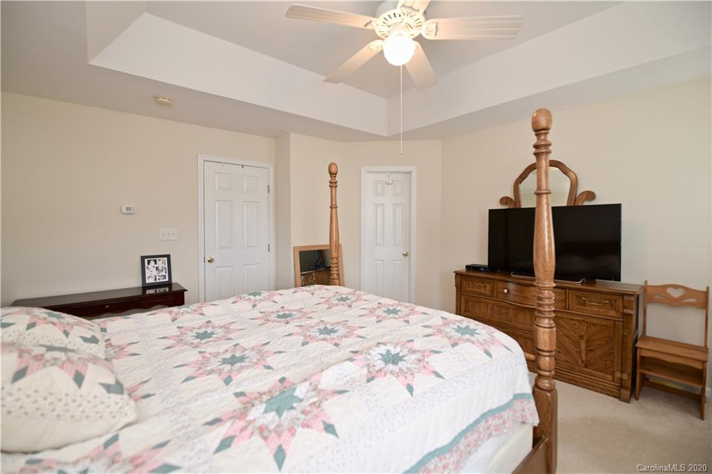 6152 Prosperity Church Road Charlotte, NC 28269 - Photo 24 of 33 a bedroom with a bed and a flat screen tv