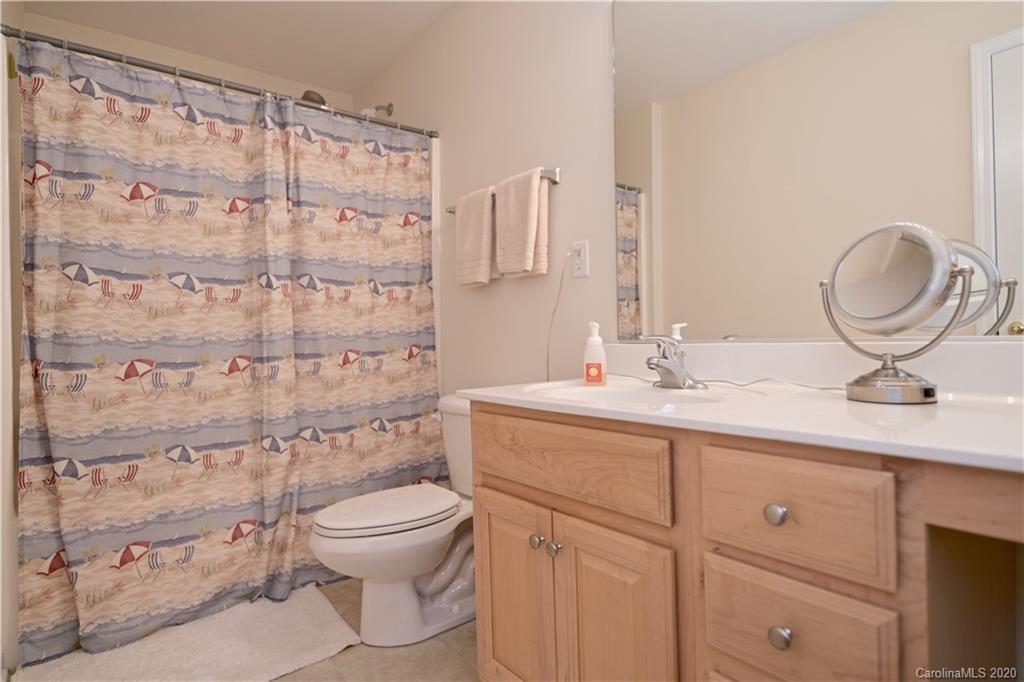 6152 Prosperity Church Road Charlotte, NC 28269 - Photo 25 of 33 a bathroom with a granite countertop sink a toilet and a shower