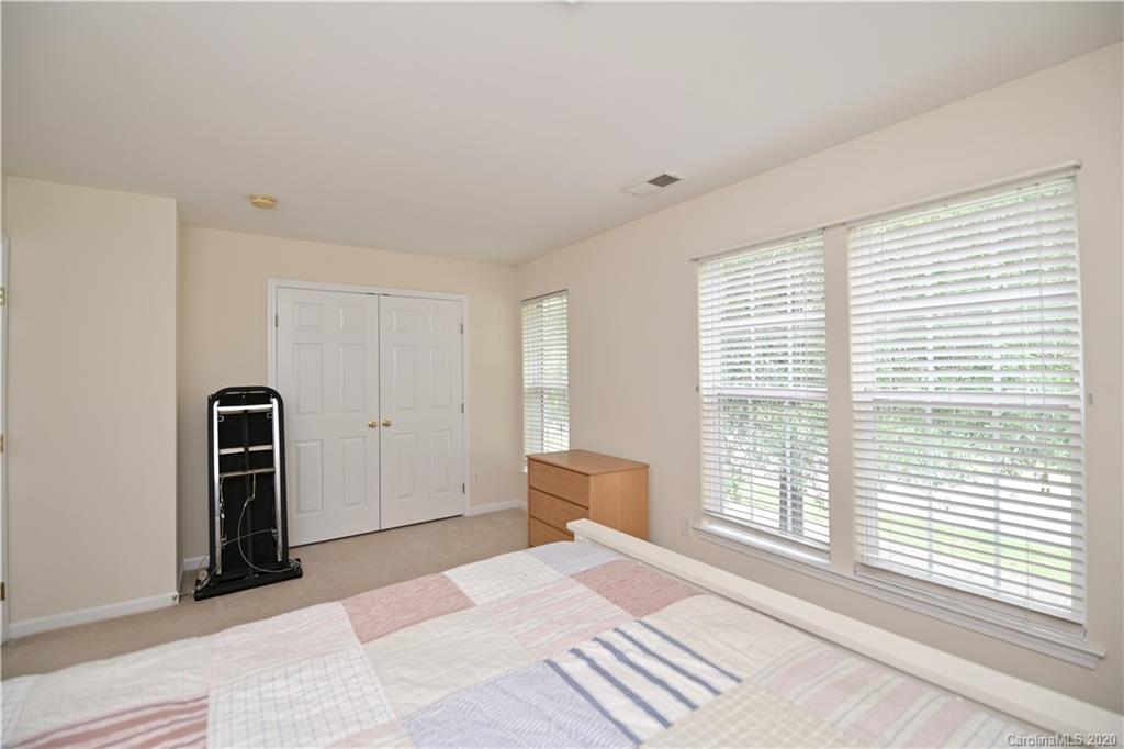 6152 Prosperity Church Road Charlotte, NC 28269 - Photo 28 of 33 a bedroom with a bed and a large window