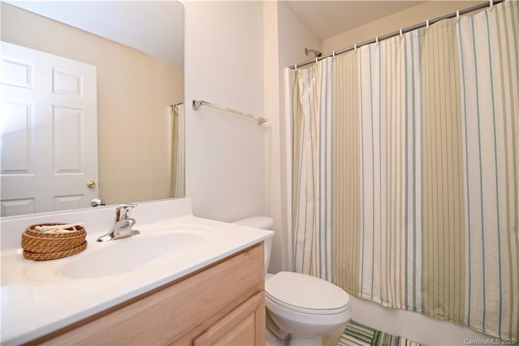 6152 Prosperity Church Road Charlotte, NC 28269 - Photo 29 of 33 a bathroom with a sink a toilet and shower curtain