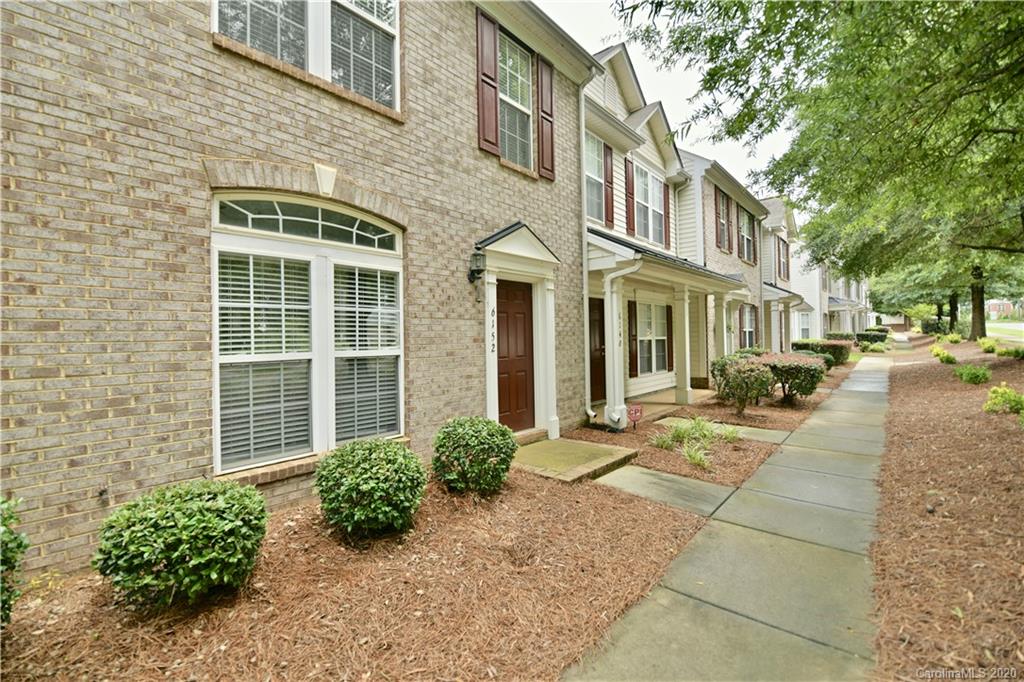 6152 Prosperity Church Road Charlotte, NC 28269 - Photo 4 of 33 a front view of a brick house with a yard
