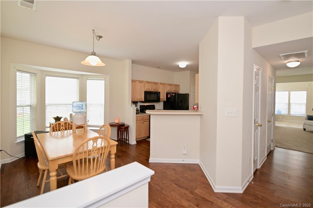 6152 Prosperity Church Road Charlotte, NC 28269 - Photo 6 of 33 a view of a dining room with furniture window and wooden floor