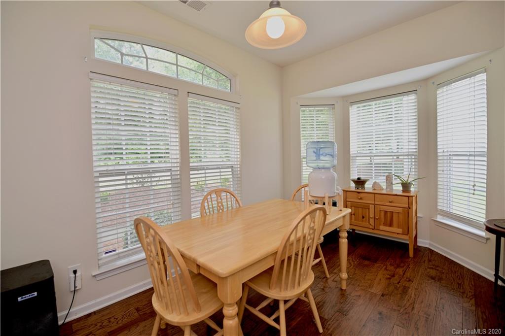 6152 Prosperity Church Road Charlotte, NC 28269 - Photo 8 of 33 a view of a dining room with furniture and wooden floor