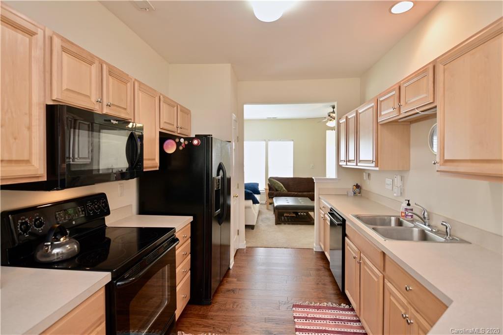 6152 Prosperity Church Road Charlotte, NC 28269 - Photo 10 of 33 a kitchen with stainless steel appliances a stove a sink a refrigerator and cabinets