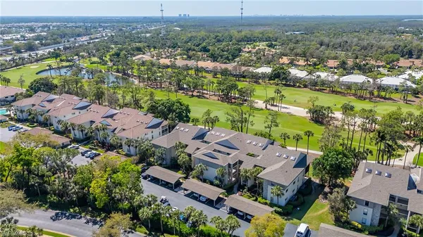 a view of a room with wooden floor cabinet and a bathroom
