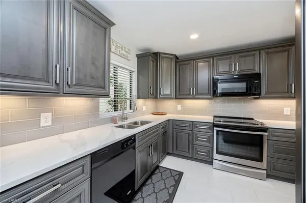 a kitchen with a refrigerator sink and stove