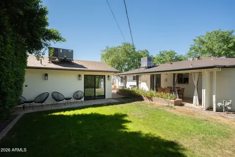 a front view of house with a garden and patio