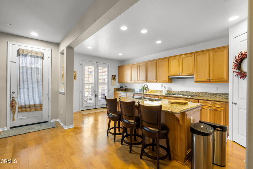 1365 Donegal Way Oxnard, CA 93035 - Photo 11 of 34 a kitchen with stainless steel appliances granite countertop a stove top oven a refrigerator a sink and a dining table with granite countertops
