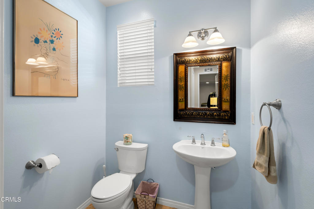 1365 Donegal Way Oxnard, CA 93035 - Photo 19 of 34 a bathroom with a toilet sink and mirror