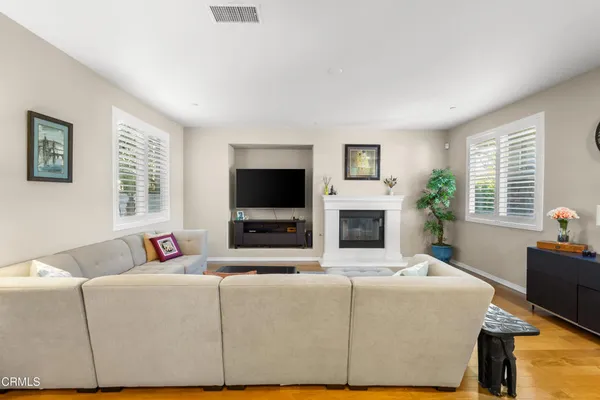 a living room with fireplace furniture and a flat screen tv