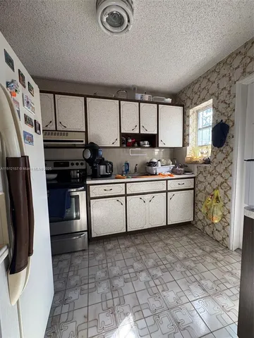 a kitchen with stainless steel appliances a stove a sink and a refrigerator