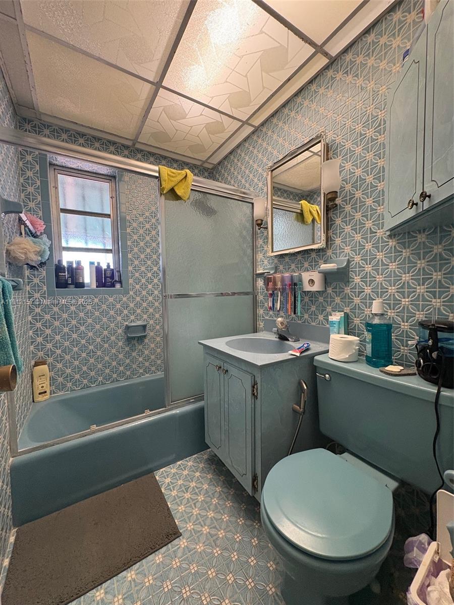 536 East 27th Street, Unit 536 Hialeah, FL 33013 - Photo 8 of 11 a bathroom with a granite countertop toilet sink and mirror