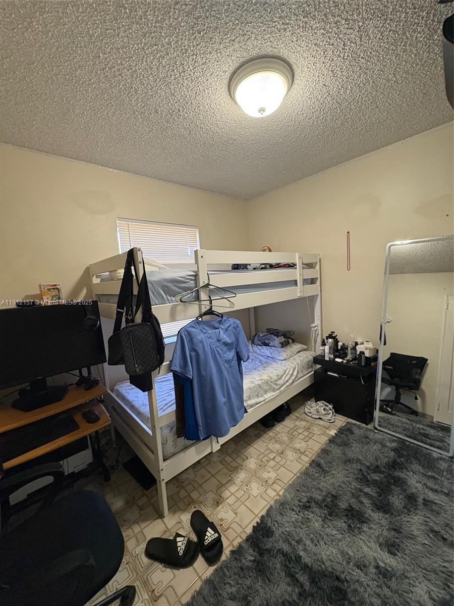 536 East 27th Street, Unit 536 Hialeah, FL 33013 - Photo 10 of 11 a bedroom with a bed and a couch